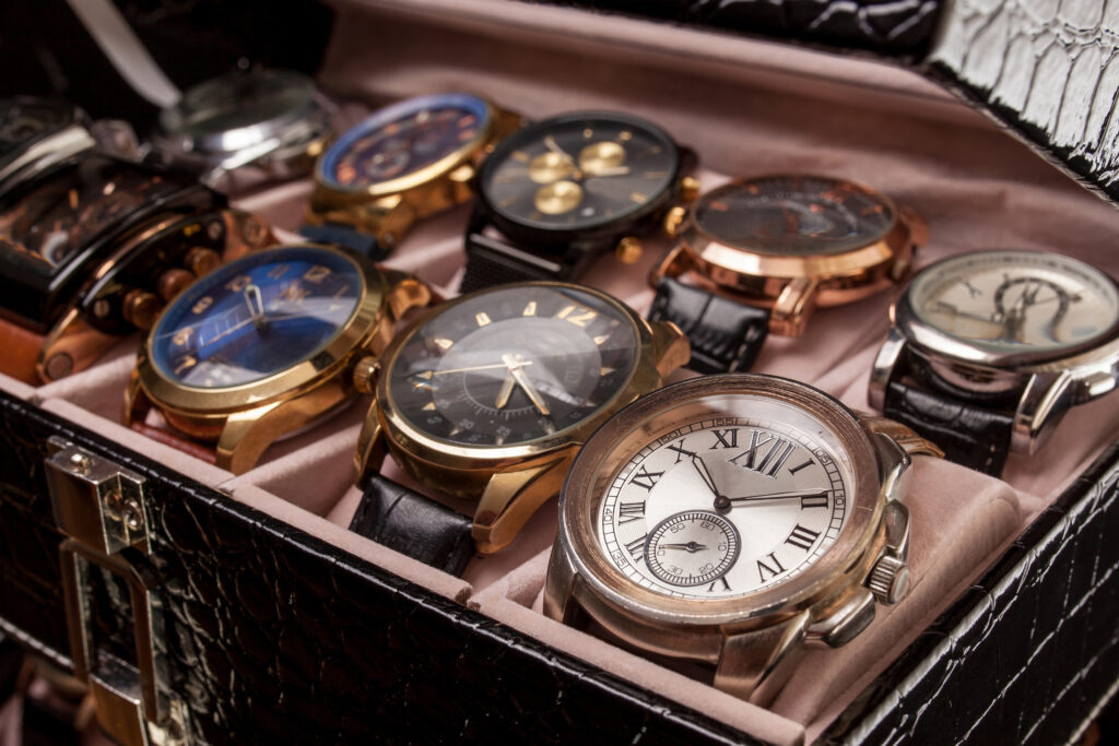 collection of mens watches in a protective case