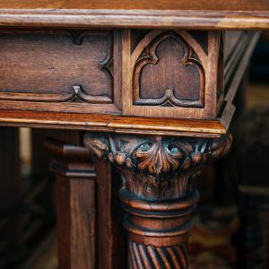 Angle and carved leg of an ancient vintage antique wooden table